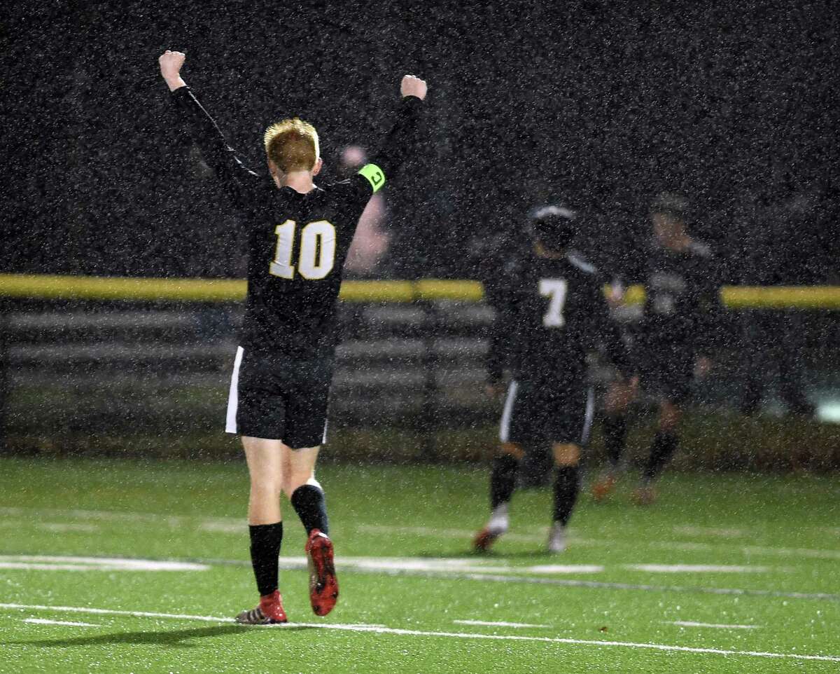 Scott Testori of Daniel Hand celebrate in the final seconds of their 3-1 victory over Guilford for the SCC Championship in Madison on November 12, 2020.