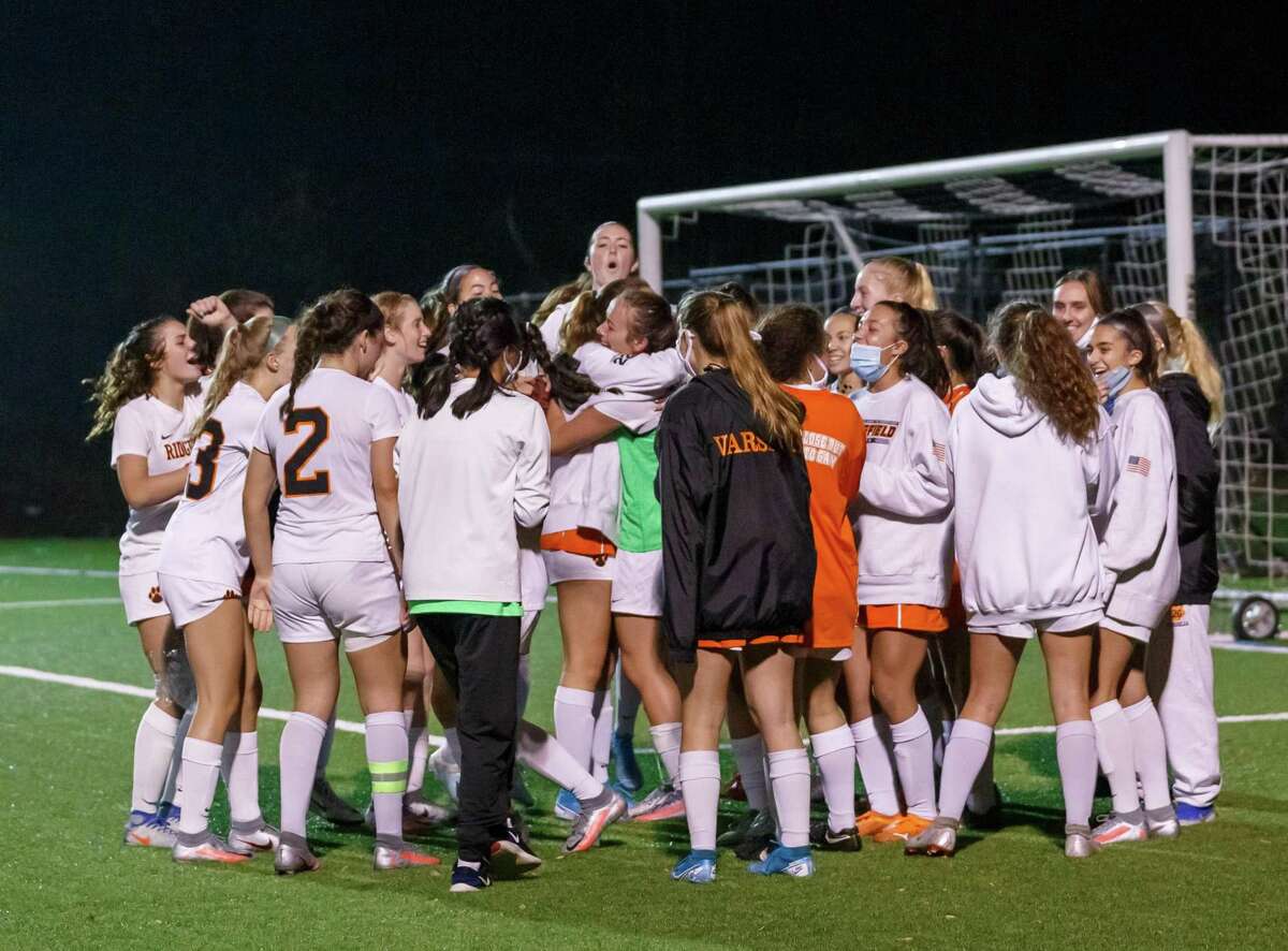 The Ridgefield girls soccer team celebrates its win over Wilton in the FCIAC Central semifinals.