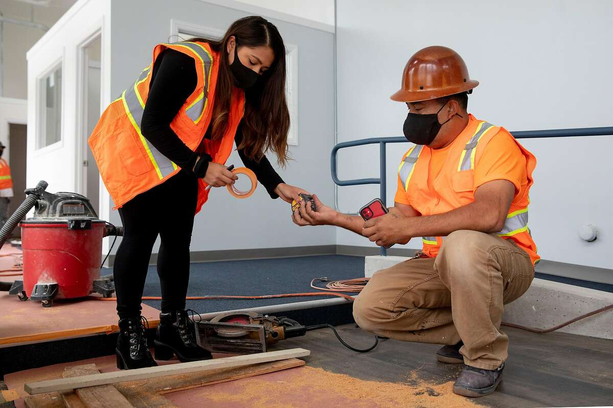 Vanessa Mejia, a beneficiary of the Deferred Action for Childhood Arrivals program, works with her father, Julio Mejia, at a Berkeley construction site.
