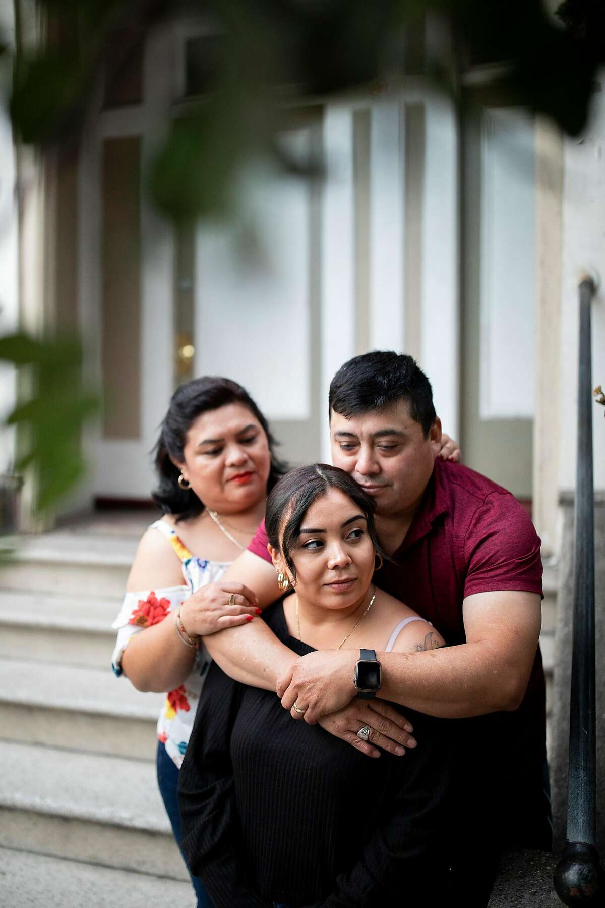 Maria Fuentes with mother Aida Ruiz and father Santos Fuentes outside her childhood home in San Francisco.