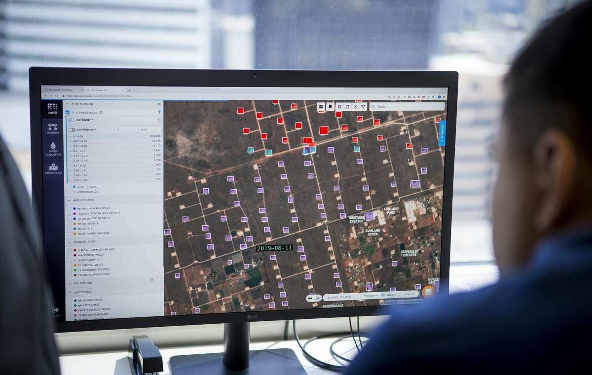 Senior full stack engineer Victor Belous and Sourcewater CEO Josh Adler looks at satellite imagery of well pad sites at the company's office in downtown Houston in this 2019 file photo. Technical skills will be as important as reservoir engineering or production engineering to the oil industry of the future, and companies should address applicants' concerns about the industry head on.