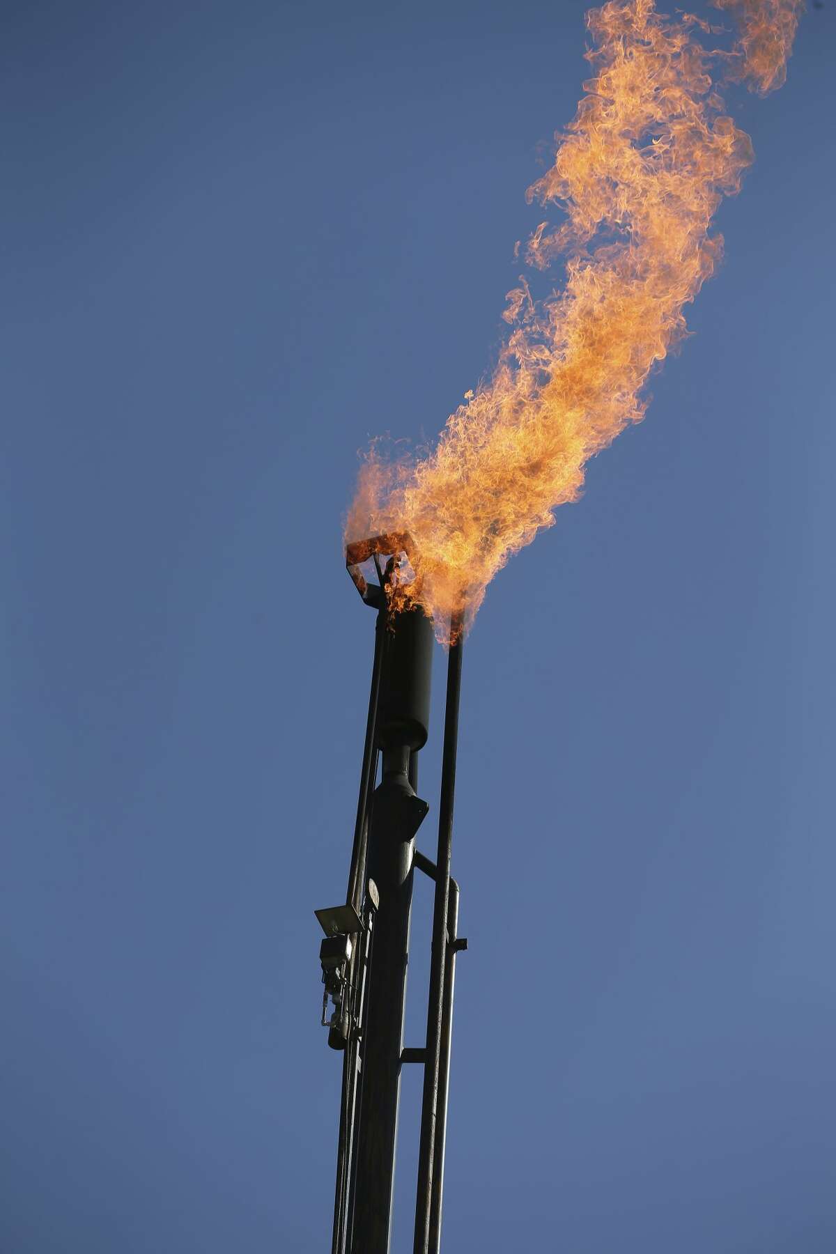 A flare stack burns gas at a Recoil Resources site in this file photo. As part of its move towards greater transparency, the Railroad Commission has launched an online flaring and venting query database. The public can now search which operators have applied for flaring exceptions and where.