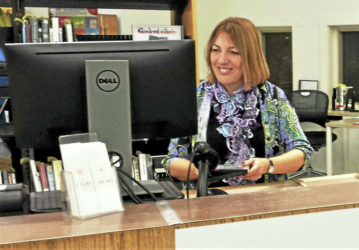 Russell Library program coordinator and host of the Book Yak on a Kayak discussion group Christy Billings is seen at the front desk of the 123 Broad St., Middletown, facility.