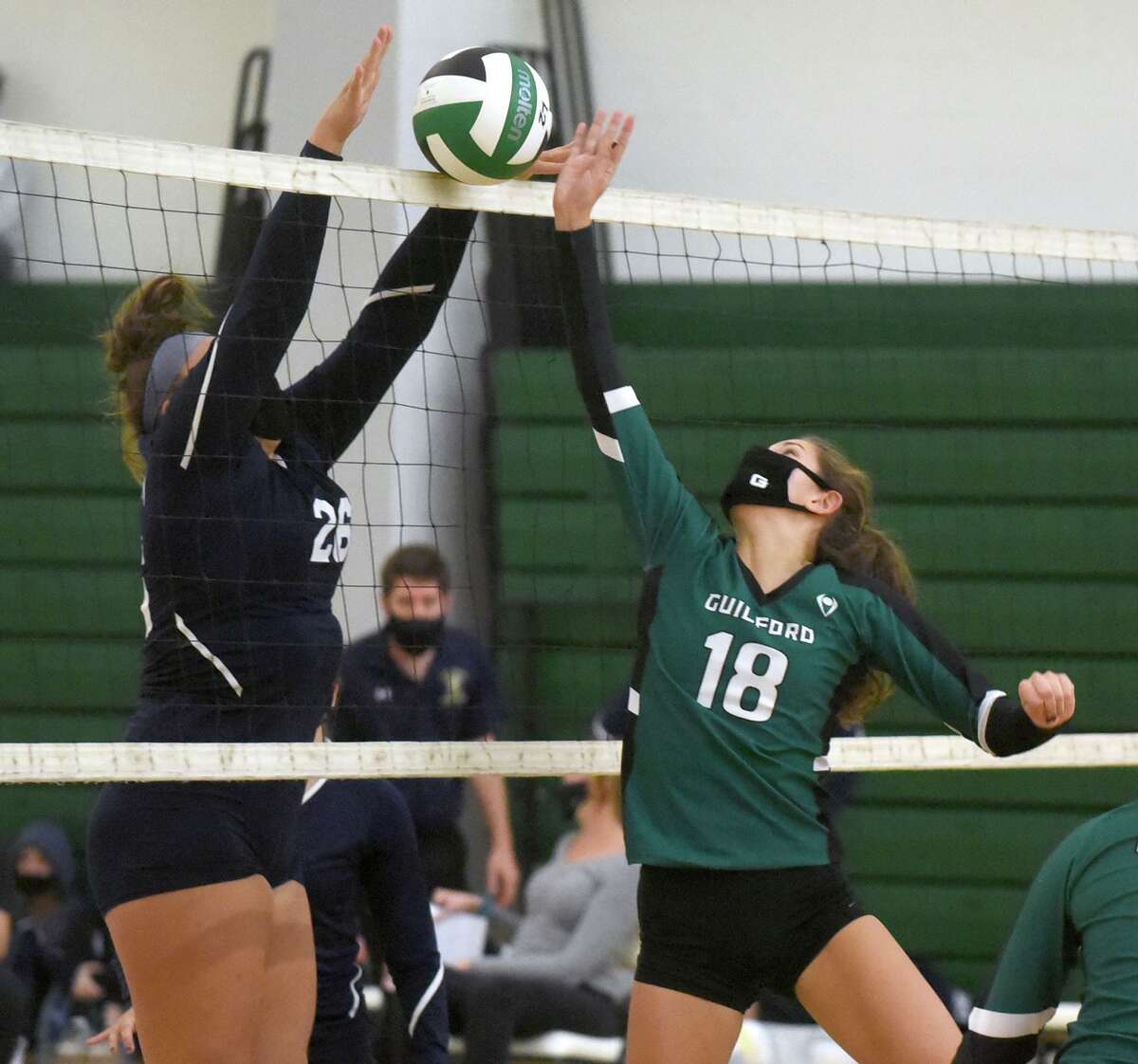 Guilford'’ Olivia Ciocca (18) battles East Haven’s Alice Stettinger at the net during the SCC Div. C volleyball final in Guilford last month.