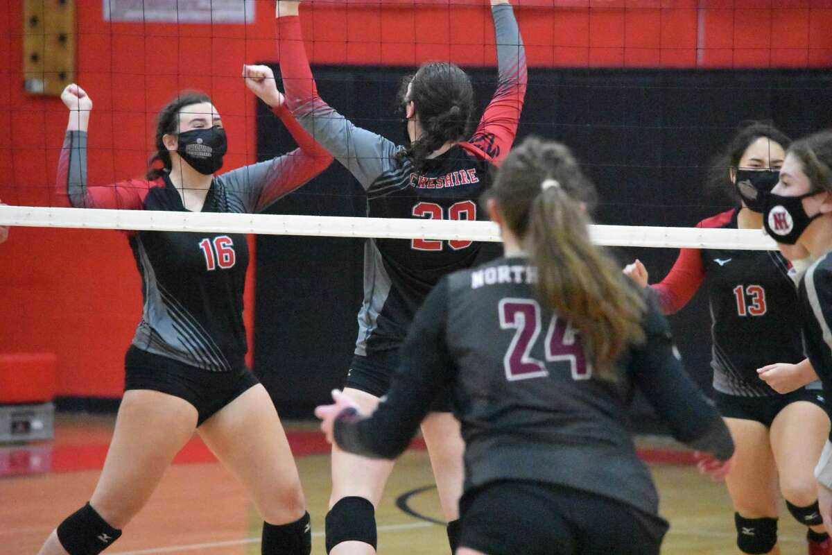 Cheshire’s Sarah Holley celebrates after blocking a ball against North Haven in the SCC Division B girls volleyball championship game at Cheshire on Friday.