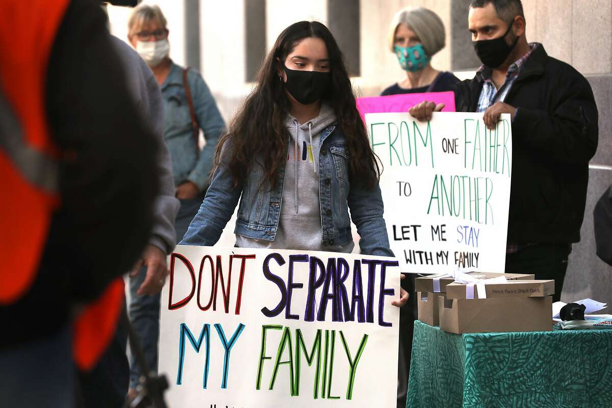 Hulissa Aguilar (middle), 14 years old, rallies with her father Hugo Aguilar (right) against his deportation in front of the U.S. immigration office on Tuesday, Oct. 27, 2020, in San Francisco, Calif. The carpenter, who is a father of 3 children who are U.S. citizens, has lived in this country for about 25 years.