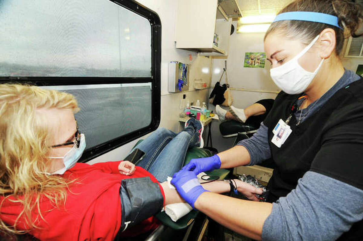 Janeen Myers, right, of Granite City, checks on blood donor Heather Maher, of Alton, during Saturday’s blood drive.