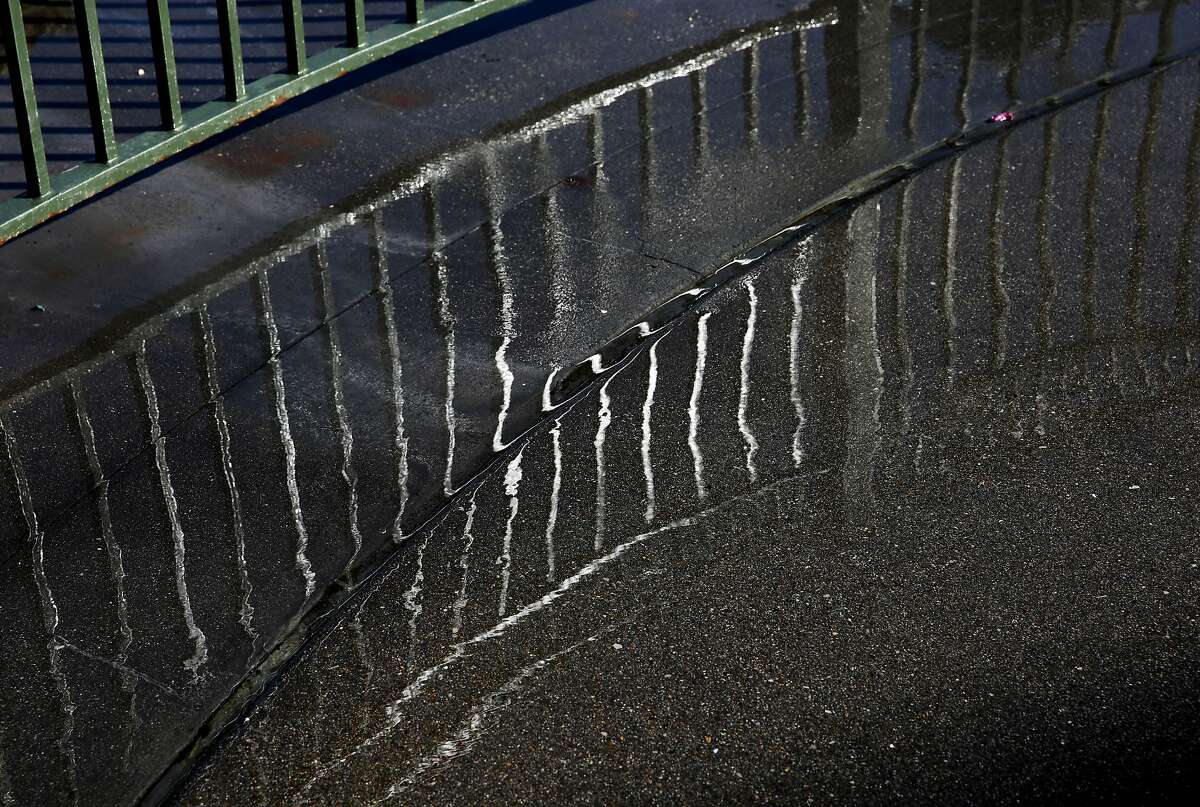 Water wets a sidewalk between Piers 3 and 5 following a past presentation on king tides sponsored by the Exploratorium in San Francisco. The king tides, which are caused by strong gravitational pulls from the moon and sun with the Earth, are forecast to bring high tides of 6.91 feet at 10:44 a.m. on Sunday in San Francisco.