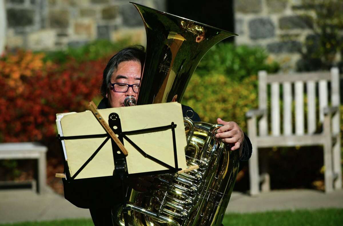 Tuba player Morris Kainuma of The Greenwich Symphony Orchestra Brass Quintet perform a special outdoor concert at The Nathaniel Witherell for senior residents and staff Saturday, November 14, 2020, in Greenwich, Conn. The performance was outdoors and residents and staff enjoyed the concert through the facility’s courtyard windows