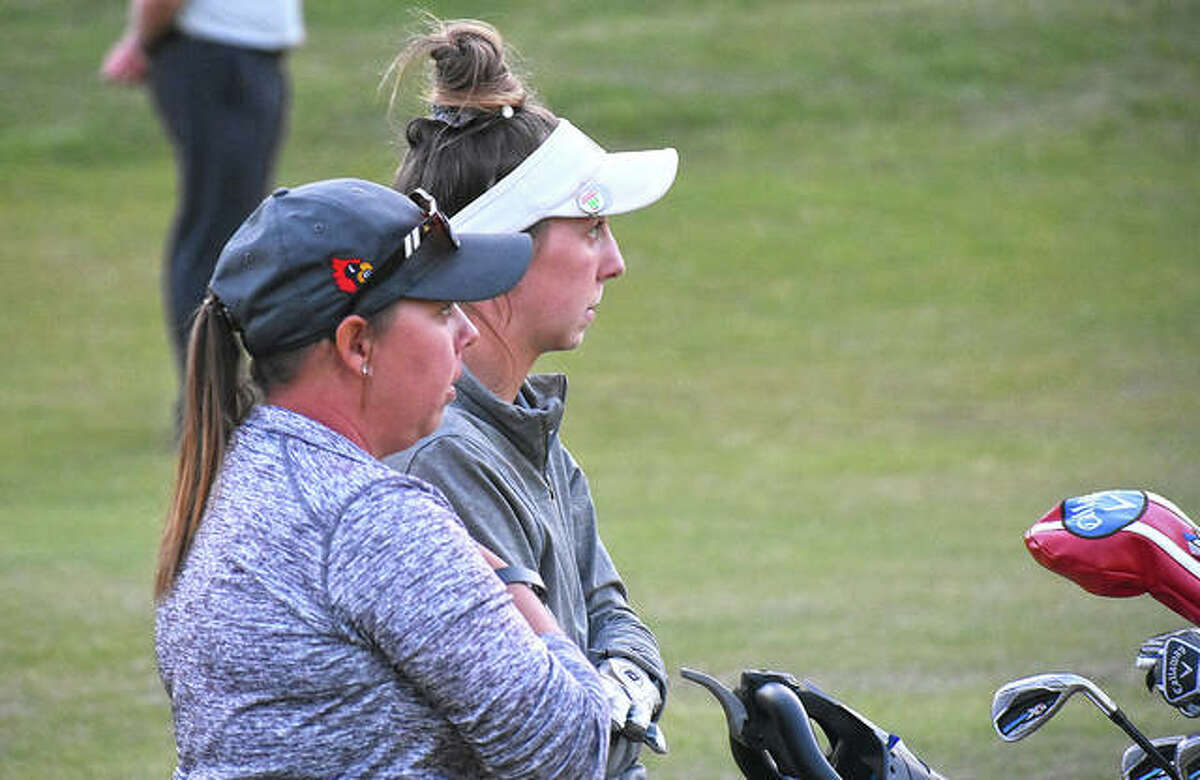 Alton golf coach Carey Cappel, left, and Redbird golfer Natalie Messinger (right) discuss a shot at the Class 2A sectional at Far Oaks in Caseyville.