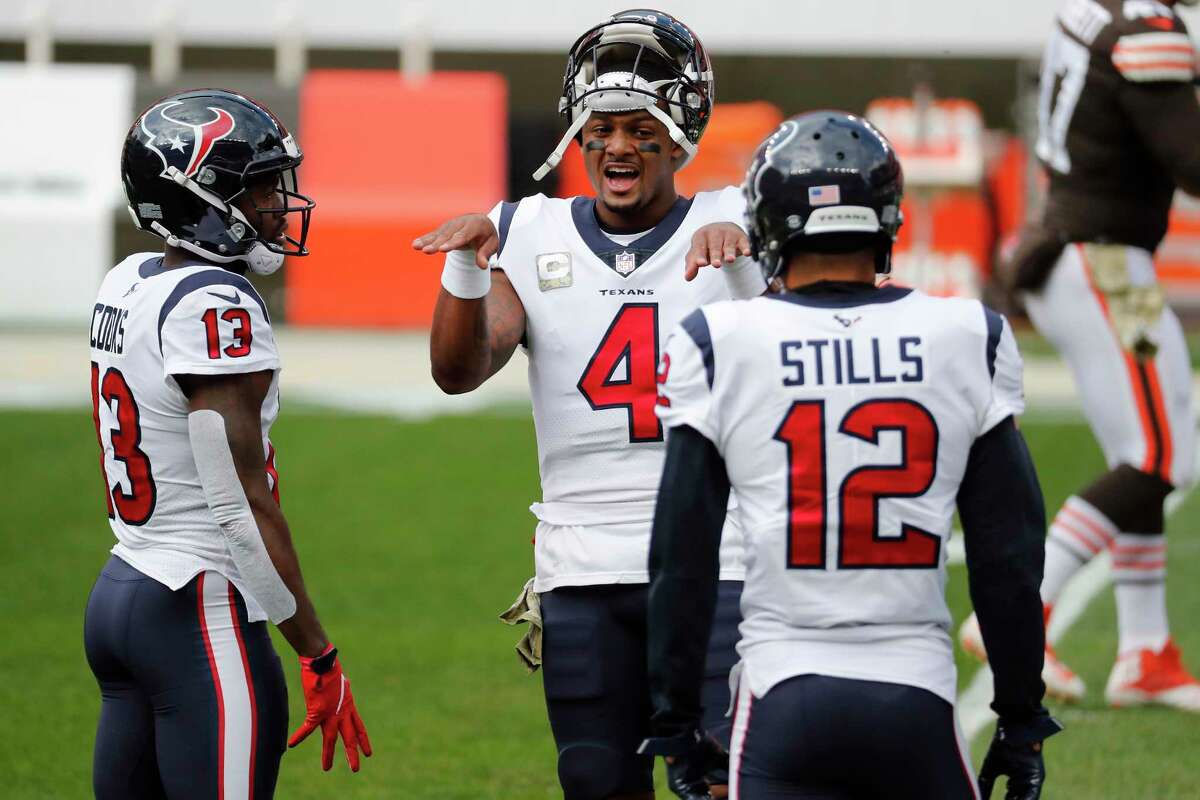 Houston Texans quarterback Deshaun Watson talks to wide receivers Brandin Cooks (13) and Kenny Stills (12) before a Nov. 15, 2020 game in Cleveland. 