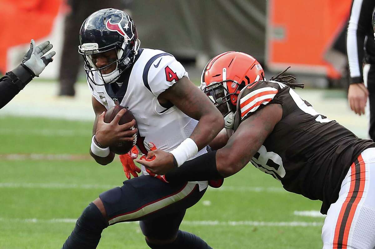 Houston Texans quarterback Deshaun Watson (4) is sacked by Cleveland Browns defensive tackle Sheldon Richardson (98) during the first half of an NFL football game at FirstEnergy Stadium Sunday, Nov. 15, 2020, in Cleveland.