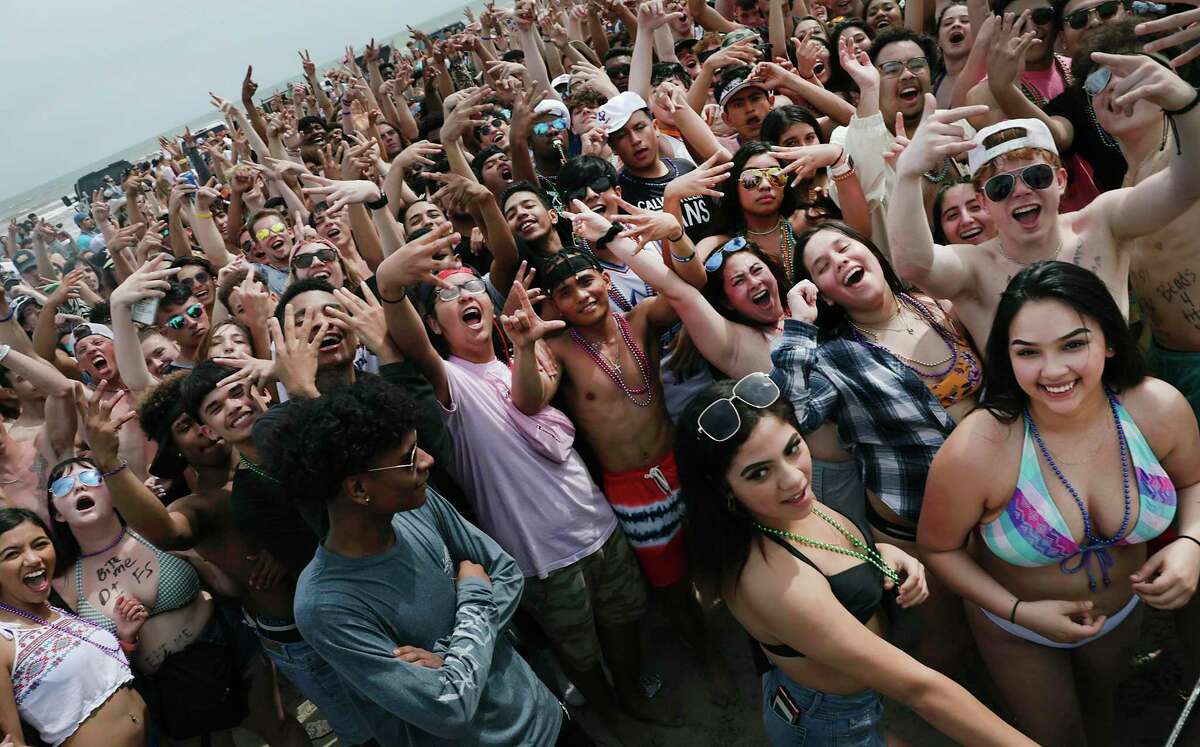 A youthful crowd dances to music by a DJ on the beach at Port Aransas. Spring Break has hit Port Aransas in a big way and it will only get bigger during the coming weekend when University of Texas and Texas State will start their spring break, on March 12, 2020.
