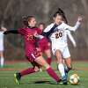 Julia Bragg (right) and the unbeaten Ridgefield girls soccer team have been named co-champs of the FCIAC Central Region.