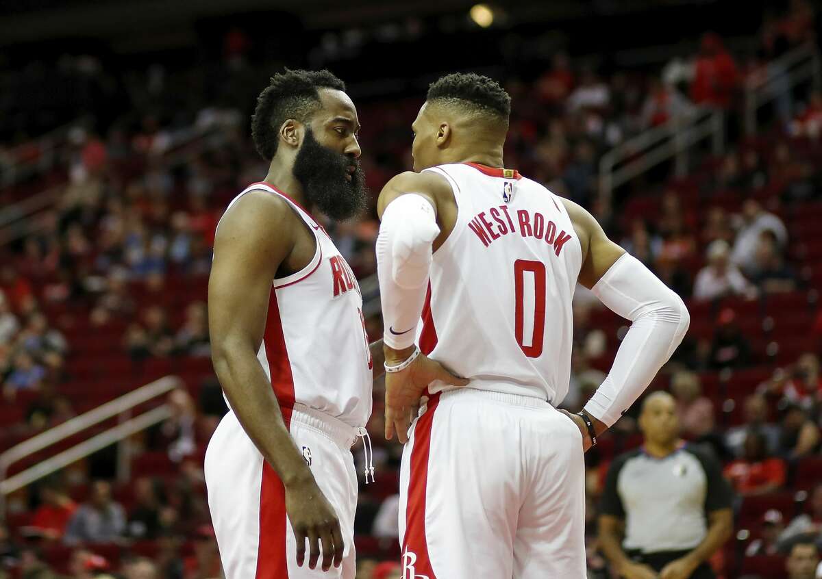 James Harden of the Houston Rockets talks with Russell Westbrook in the first half against the Orlando Magic at Toyota Center on March 08, 2020 in Houston, Texas.