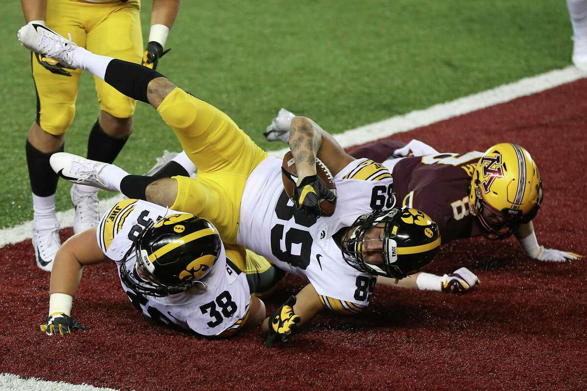 Iowa wide receiver Nico Ragaini (89) scores a touchdown against Minnesota during the first half NCAA college football game Friday, Nov. 13, 2020, in Minneapolis. (AP Photo/Stacy Bengs)