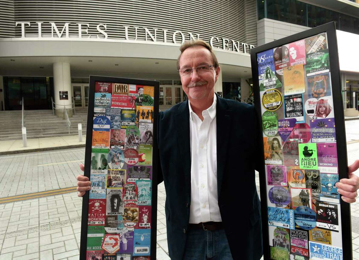 Bob Belber, general manager of the Times Union Center, stands outside the arena with part of his collection of 350 backstage passes for shows at the arena he will be auctioning on Monday Nov. 16, 2020 in Albany, N.Y. He is hoping to raise at least $70,000. He will be donating a portion of proceeds to the 23 full-time Times Union Center employees who were furloughed at the beginning of the pandemic. (Lori Van Buren/Times Union)