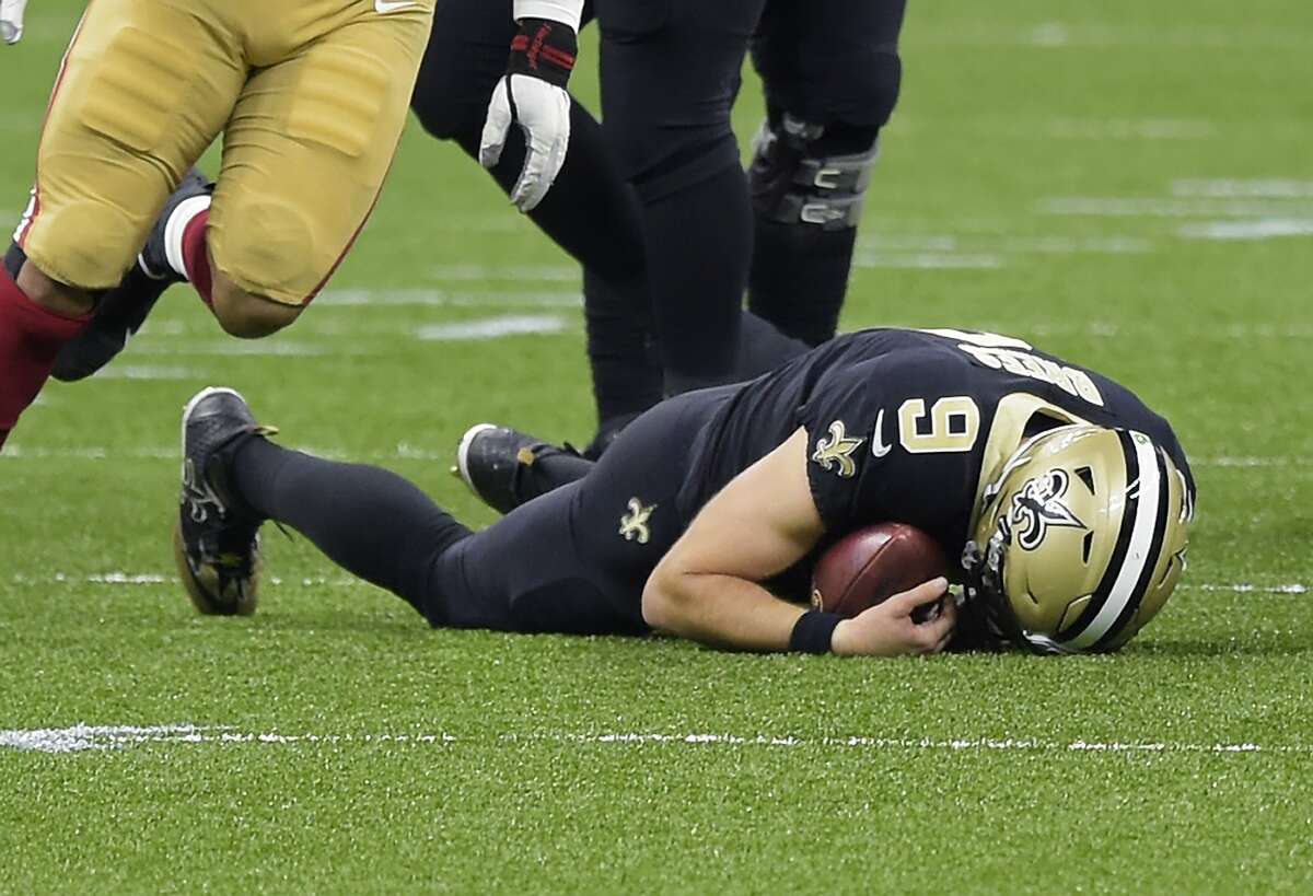 New Orleans Saints quarterback Drew Brees (9) remains on the ground after being sacked by San Francisco 49ers' Kentavius Street during the second quarter of an NFL football game in New Orleans, Sunday, Nov. 15, 2020. Brees has been diagnosed with multiple rib fractures and a collapsed right lung, a person with knowledge of the situation said Monday. The person spoke on condition of anonymity because the Saints have not announced specifics about Brees' injury, which the 41-year-old quarterback said occurred on a heavy hit by Street in the second quarter of New Orleans victory over the Niners on Sunday.