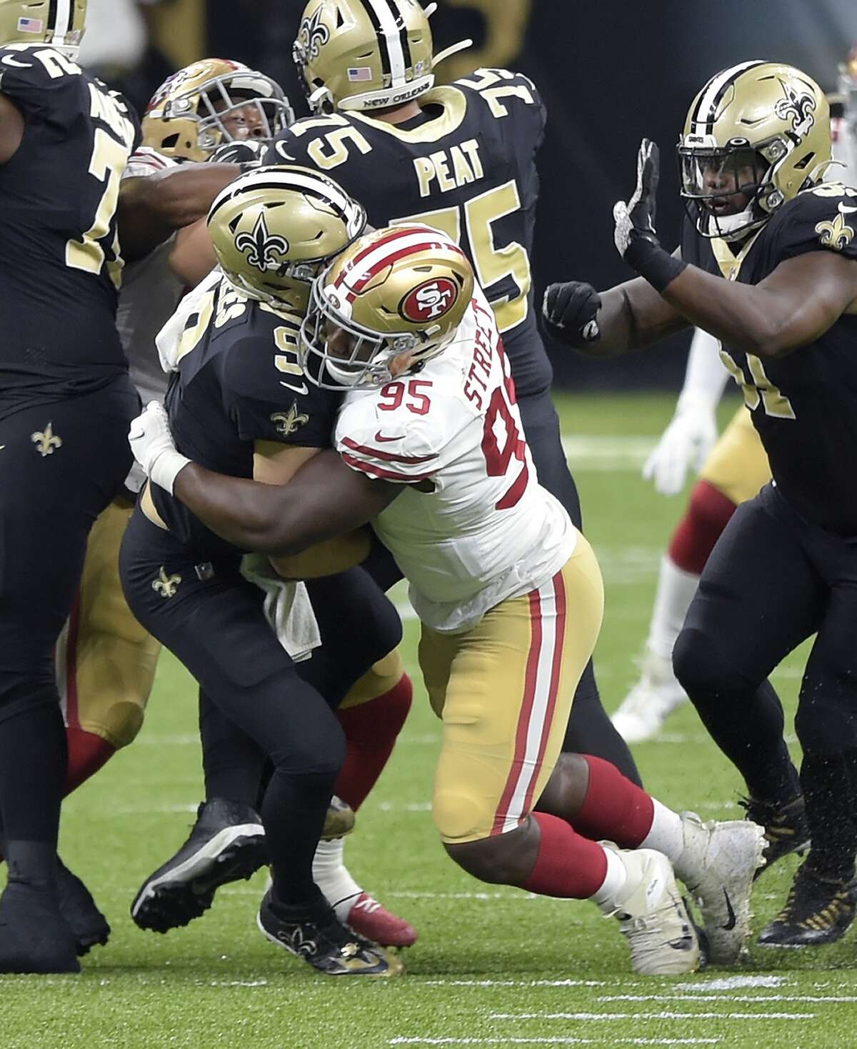 New Orleans Saints quarterback Drew Brees (9) is sacked by San Francisco 49ers' Kentavius Street (95) during the second quarter of an NFL football game in New Orleans, Sunday, Nov. 15, 2020. Brees has been diagnosed with multiple rib fractures and a collapsed right lung, a person with knowledge of the situation said Monday. The person spoke on condition of anonymity because the Saints have not announced specifics about Brees' injury, which the 41-year-old quarterback said occurred on a heavy hit by Street in the second quarter of New Orleans victory over the Niners on Sunday.