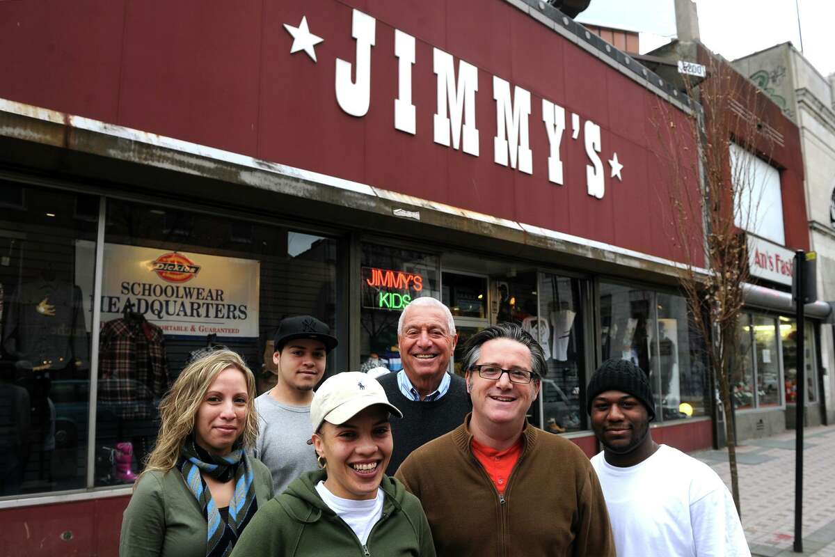 Bob Schneider and his son Dave (center) stand in front of Jimmy's Hip Hop with store employees (from left) Jasmin Guzman, Steven Nieves, Jacenia Guzman and Fidel Hernaiz, Nov. 30th, 2010. Jimmy's was opened as an Army and Navy surplus store on Main Street in Bridgeport in 1920 by Bob's father Max "Jimmy" Schneider.