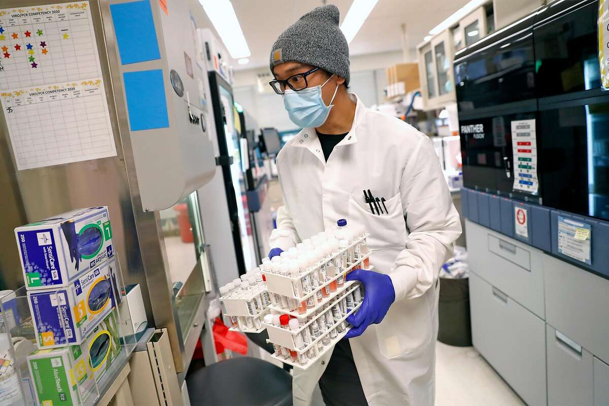 Lab technician Jason Tran processes coronavirus tests at UCSF Microbiology Laboratory at China Basin in San Francisco.