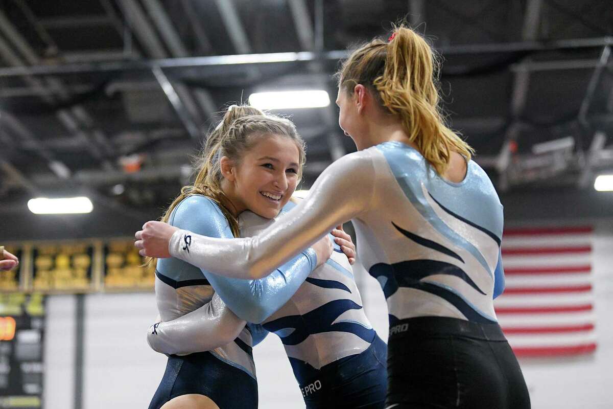 Wilton’ Lilly Byrnes is congratulated after competing in the floor exercise during the CIAC Class M Gymnastics Championship at Jonathan Law, Saturday, February 29, 2020.