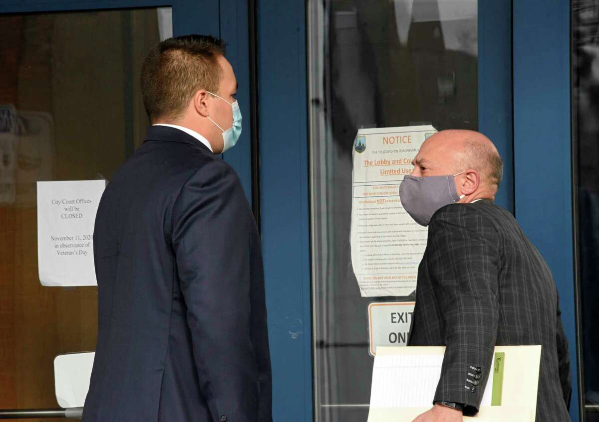 Eugene Sellie, left, the Schenectady County jail guard who was fired last week after beating a man at the Schenectady County jail, walks into Schenectady Police Department Headquarters with his attorney Andrew Safranko to face charges in connection with the attack on Tuesday, Nov. 17, 2020 in Schenectady, N.Y. (Lori Van Buren/Times Union)