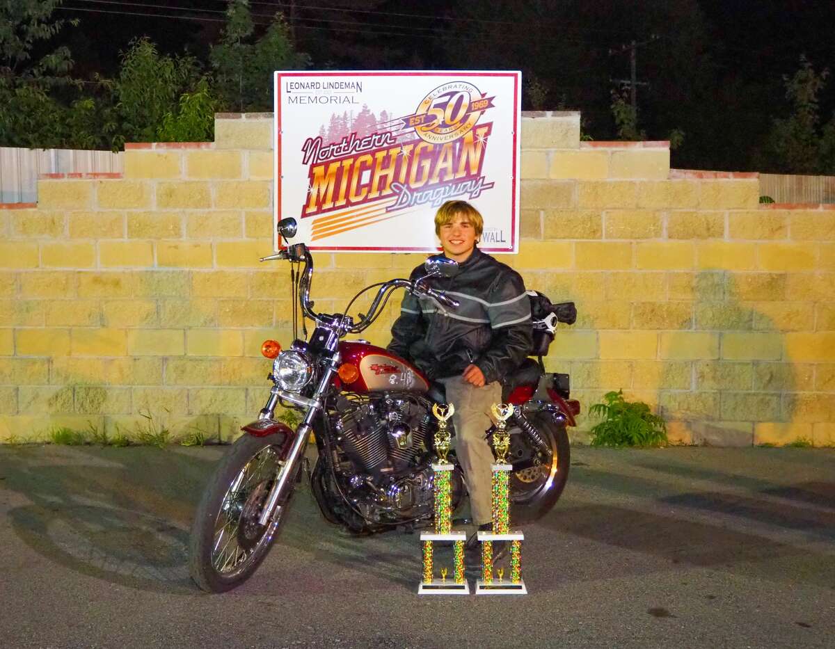 Kevin Dean is shown at the Northern Michigan Dragway behind several trophies. According to Dean's obituary, he loved drag racing and was recently named high school champion at the Northern Michigan Dragway, in Kaleva.