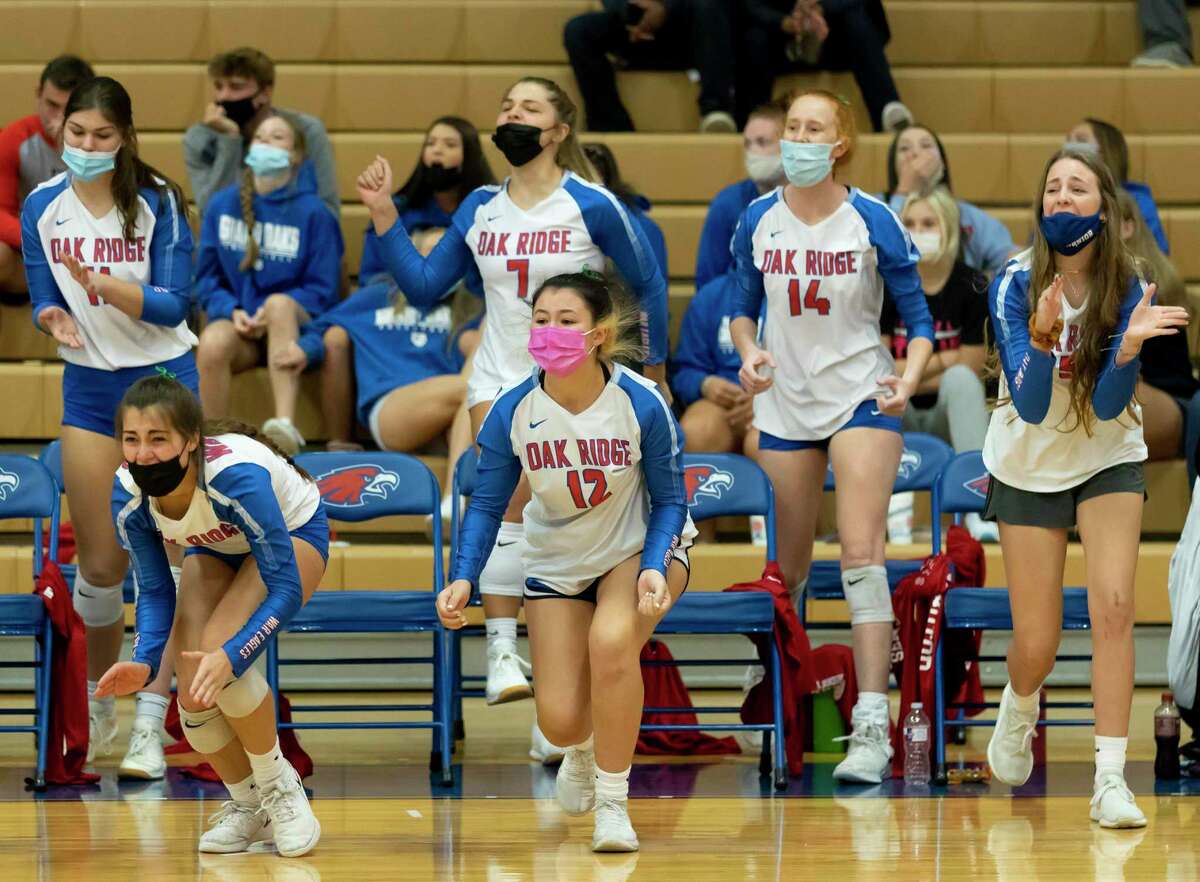 In this file photo, Oak Ridge volleyball players react after they win first set of a District 13-6A volleyball match against The Woodlands at Oak Ridge High School in Oak Ridge North.