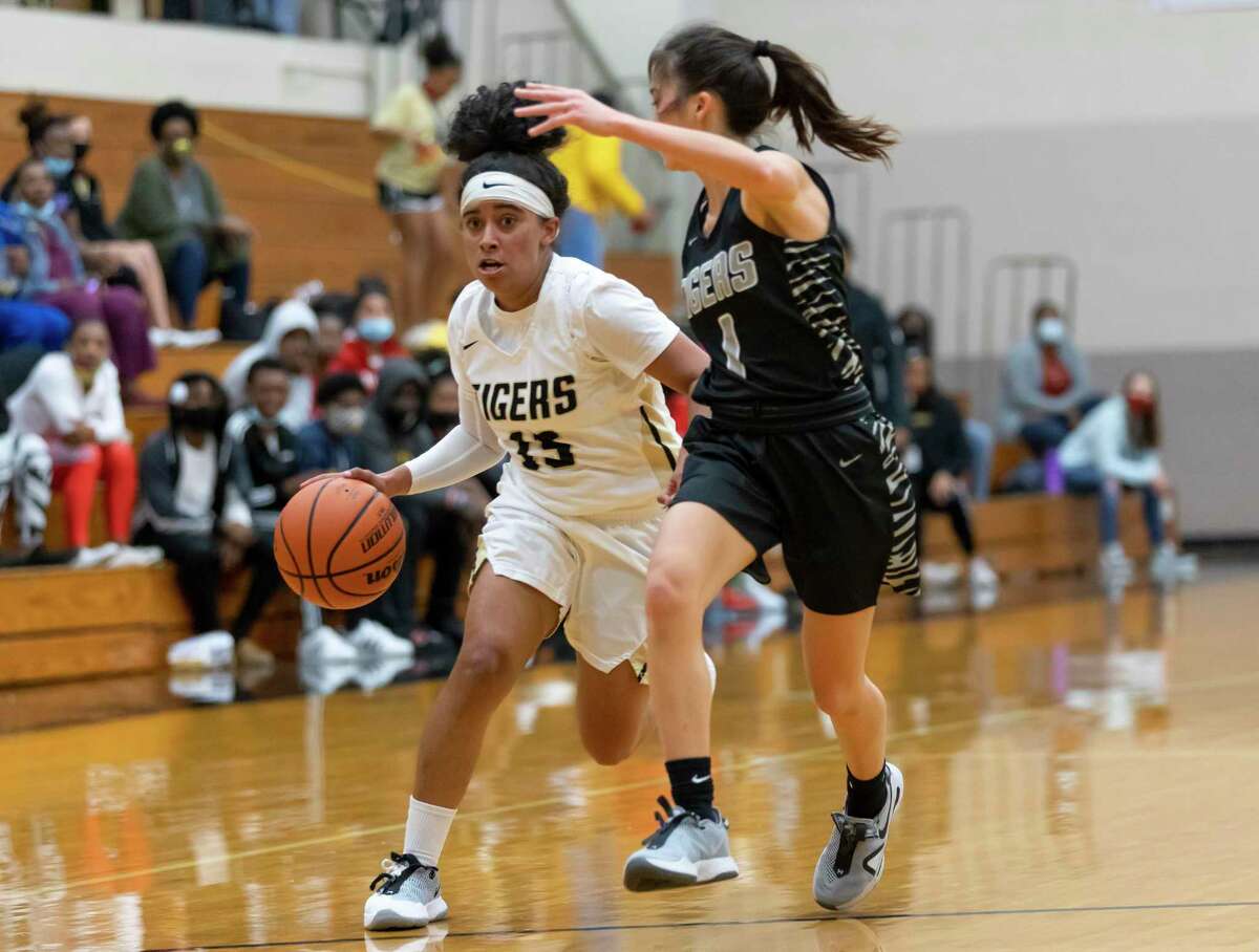 Conroe senior Daniela Galindo (15) drives the ball down the court while under pressure from A&M Consolidated junior Sarah Hathorn (1) during the second quarter of a non-district high school basketball game at Conroe High School, Tuesday, Nov. 17, 2020, in Conroe.