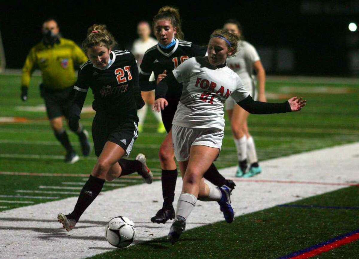 Mia Lowenberg for Foran looks to gain possession in the Lions' SCC divisional final with Shelton.
