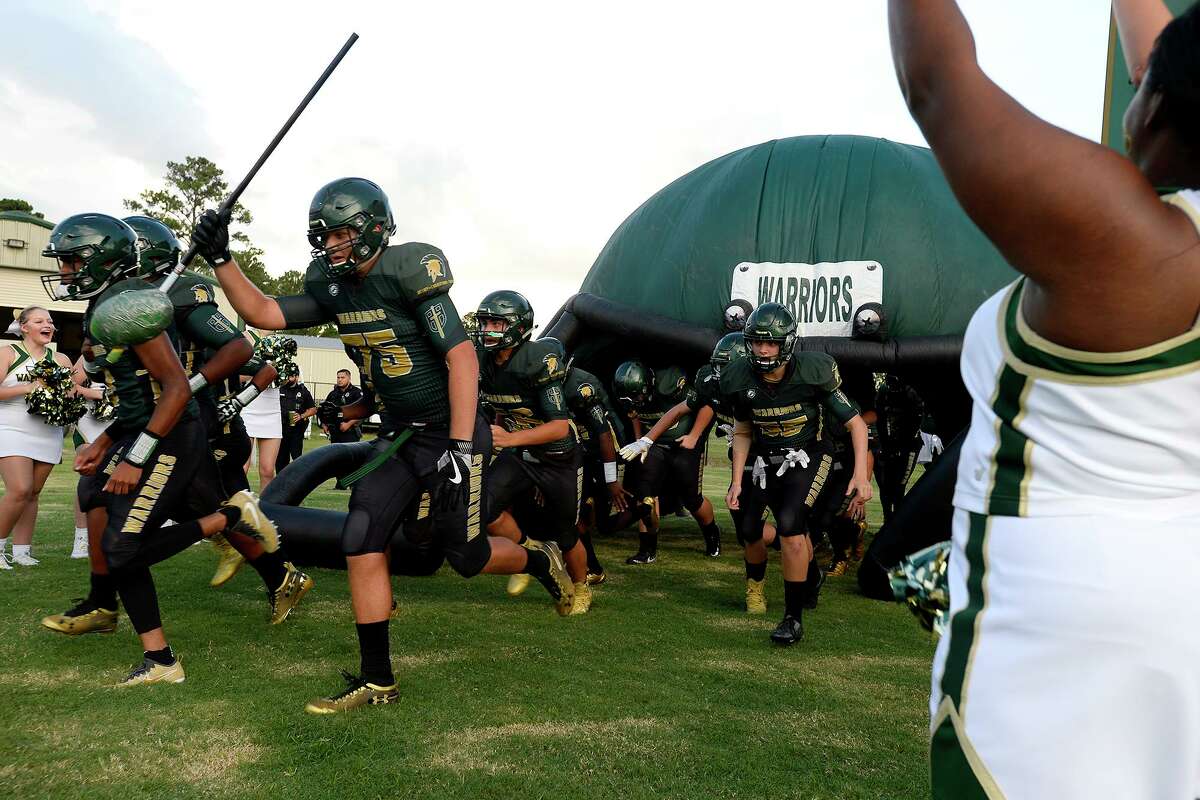 Legacy Christian Academy players run onto the field before playing Kelly Catholic. Photo taken Friday 9/7/18 Ryan Pelham/The Enterprise