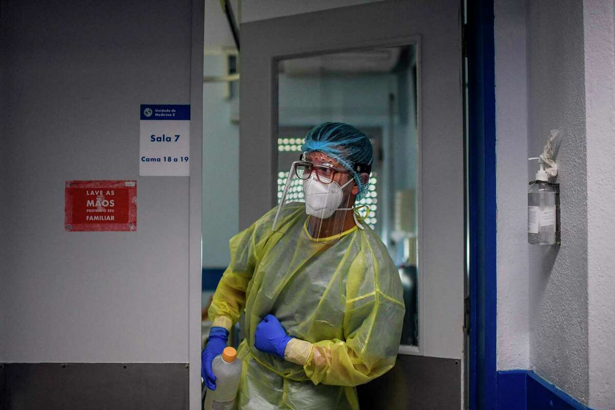 A health worker enters a room at the Covid-19 ward of the Curry Cabral hospital in Lisbon on November 18, 2020. - Pfizer and BioNTech said that a completed study of their experimental Covid-19 vaccine showed it was 95 percent effective. (Photo by PATRICIA DE MELO MOREIRA / AFP) (Photo by PATRICIA DE MELO MOREIRA/AFP via Getty Images)