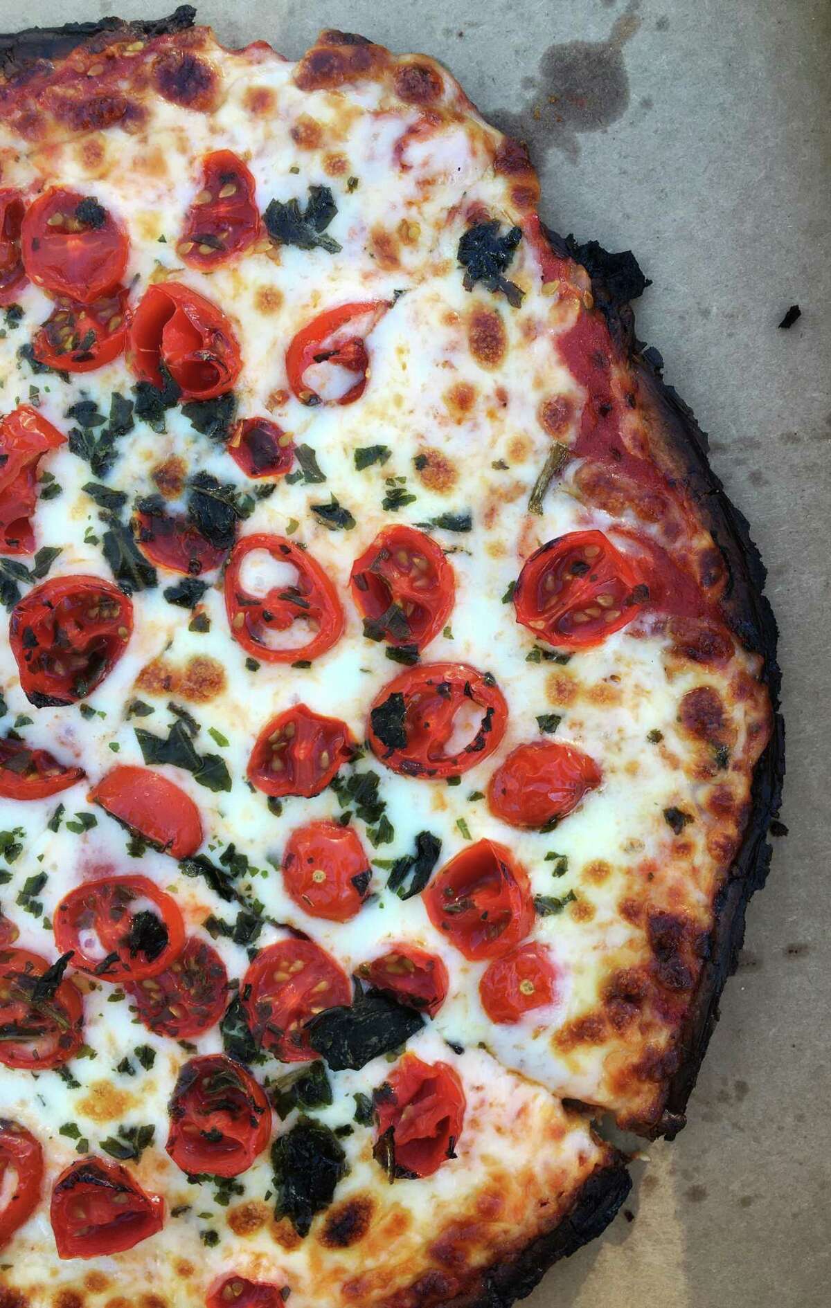 The Margherita pizza at Nico's Pizzeria is loaded with cherry tomatoes.