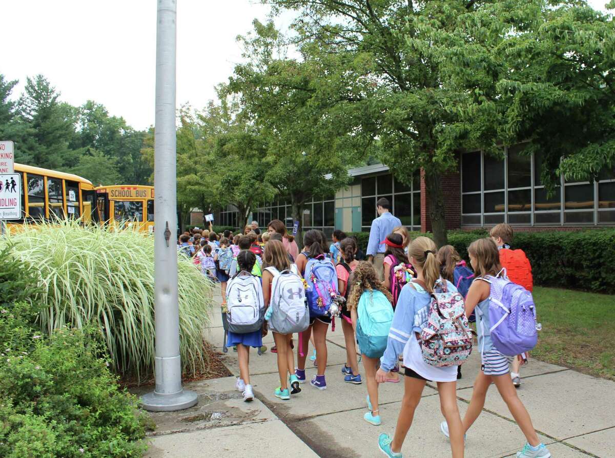 Students board buses after the first day of school on Sept. 1, 2016 at Mill Hill Elementary School in Fairfield, Conn.