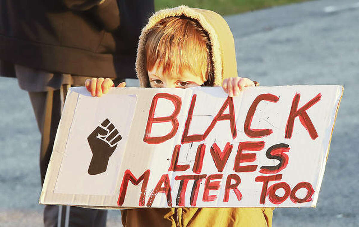 4-year-old Maveric Homer of Alton holds up a sign Wednesday on a parking lot near the Madison County Courthouse where he was attending a Black Lives Matter protest with his mother. About 40 to 50 BLM protestors turned out ahead of the Madison County Board meeting where they were expected to discuss a resolution supporting police by declaring “Blue Lives Matter.” The protestors listened to speeches and sang chants as they stood socially distanced.