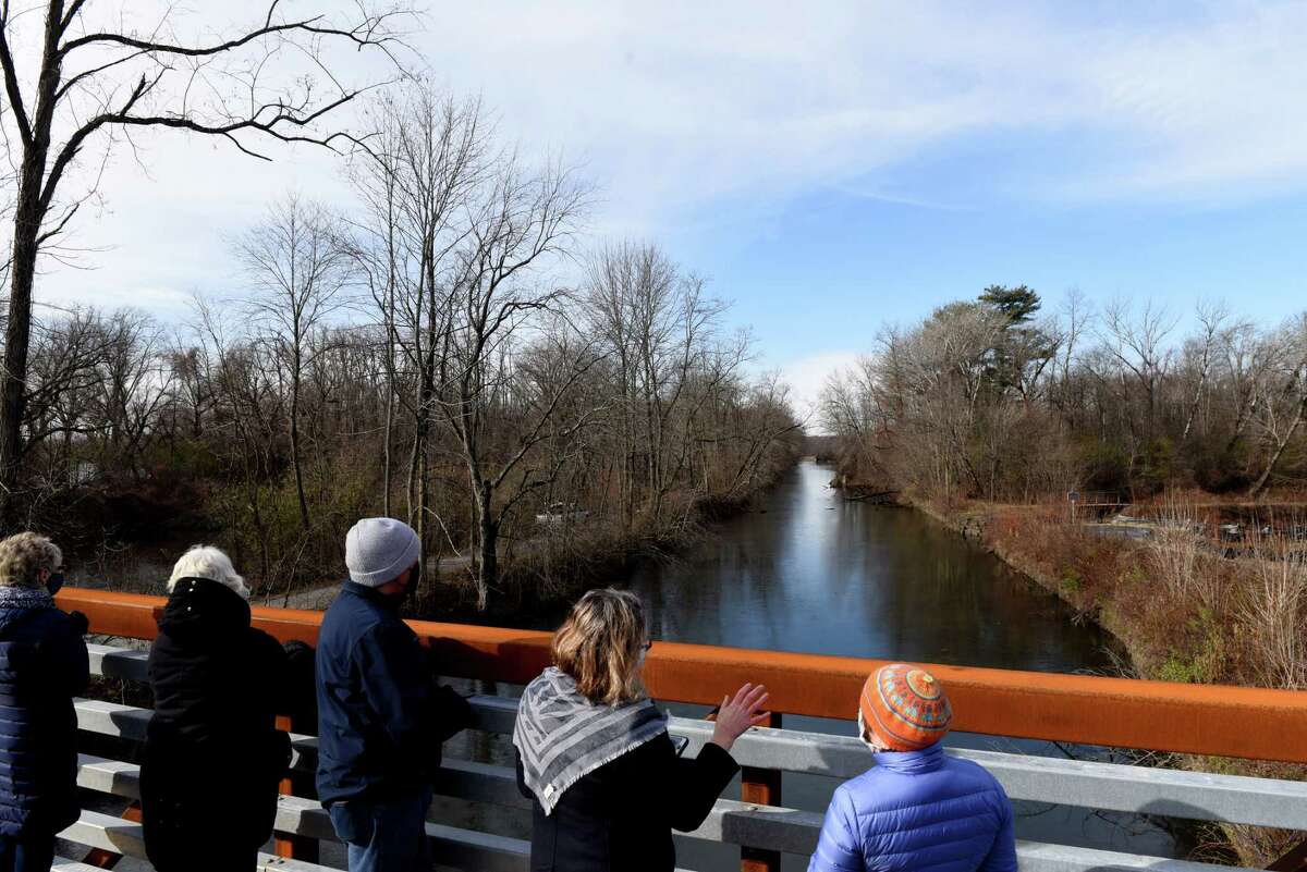 Guests of a ribbon cutting for the completion of a new pedestrian bridge at Clute?•s Dry Dock in the Vischer Ferry Nature & Historic Preserve view a stretch of the old Erie Canal from the new bridge on Thursday, Nov. 19, 2020, off Riverview Road in Clifton Park, N.Y. The Erie Canal system will open May 21, 2021 for the season. (Will Waldron/Times Union)