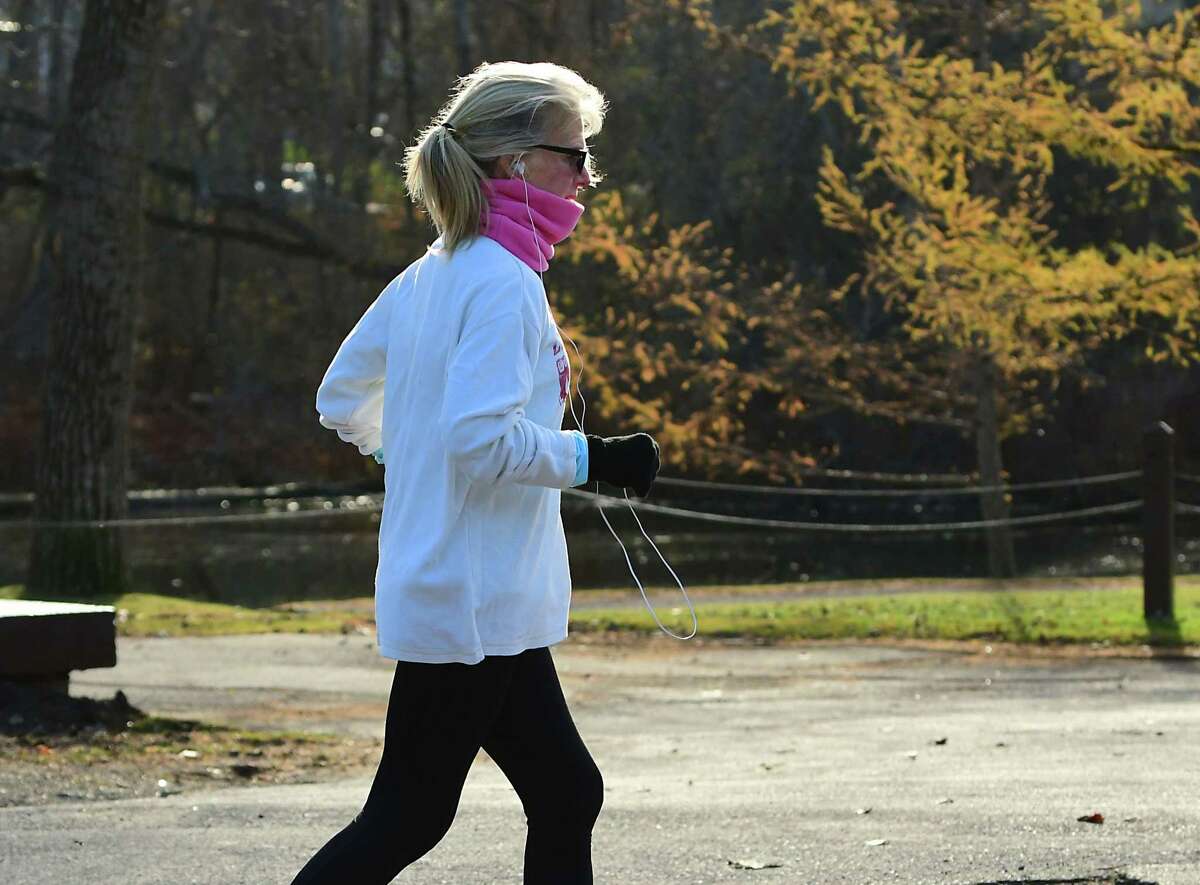 A woman is seen jogging near Buckingham Pond on Thursday, Nov. 19, 2020 in Albany, N.Y. (Lori Van Buren/Times Union)