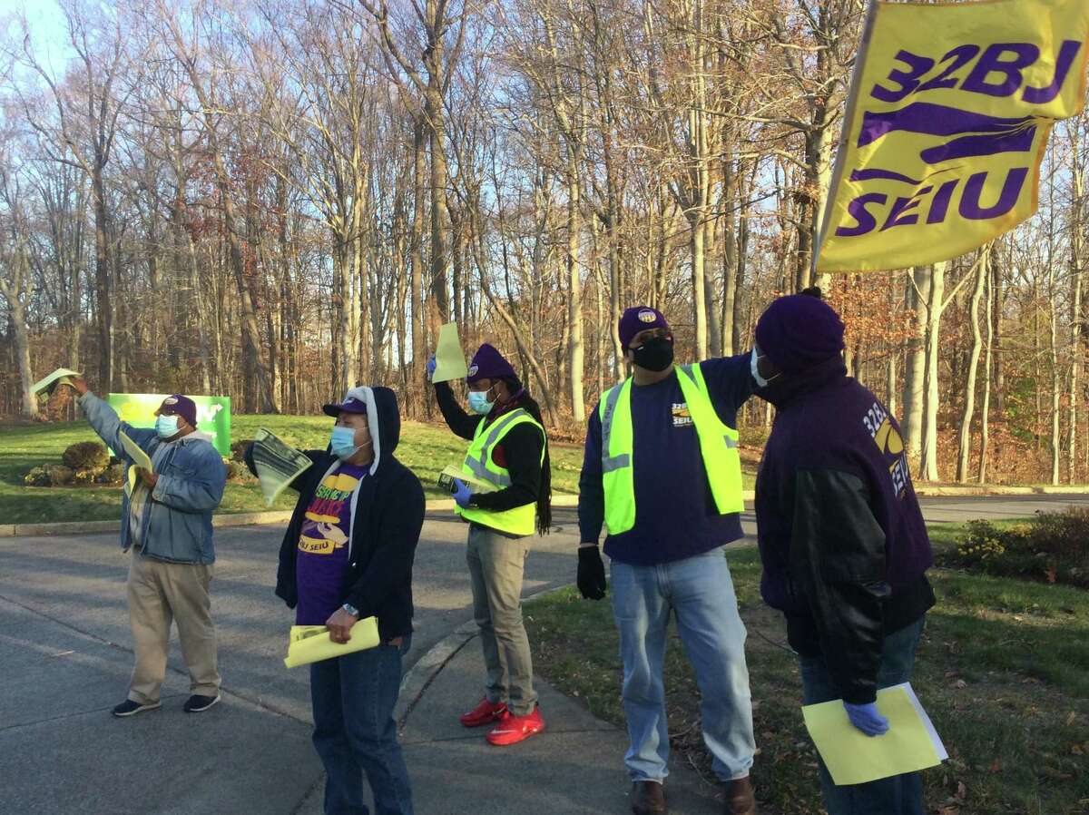 Members of the Service Employees International Union Local 32BJ rally in front of Subway headquarters in Milford on Thursday.