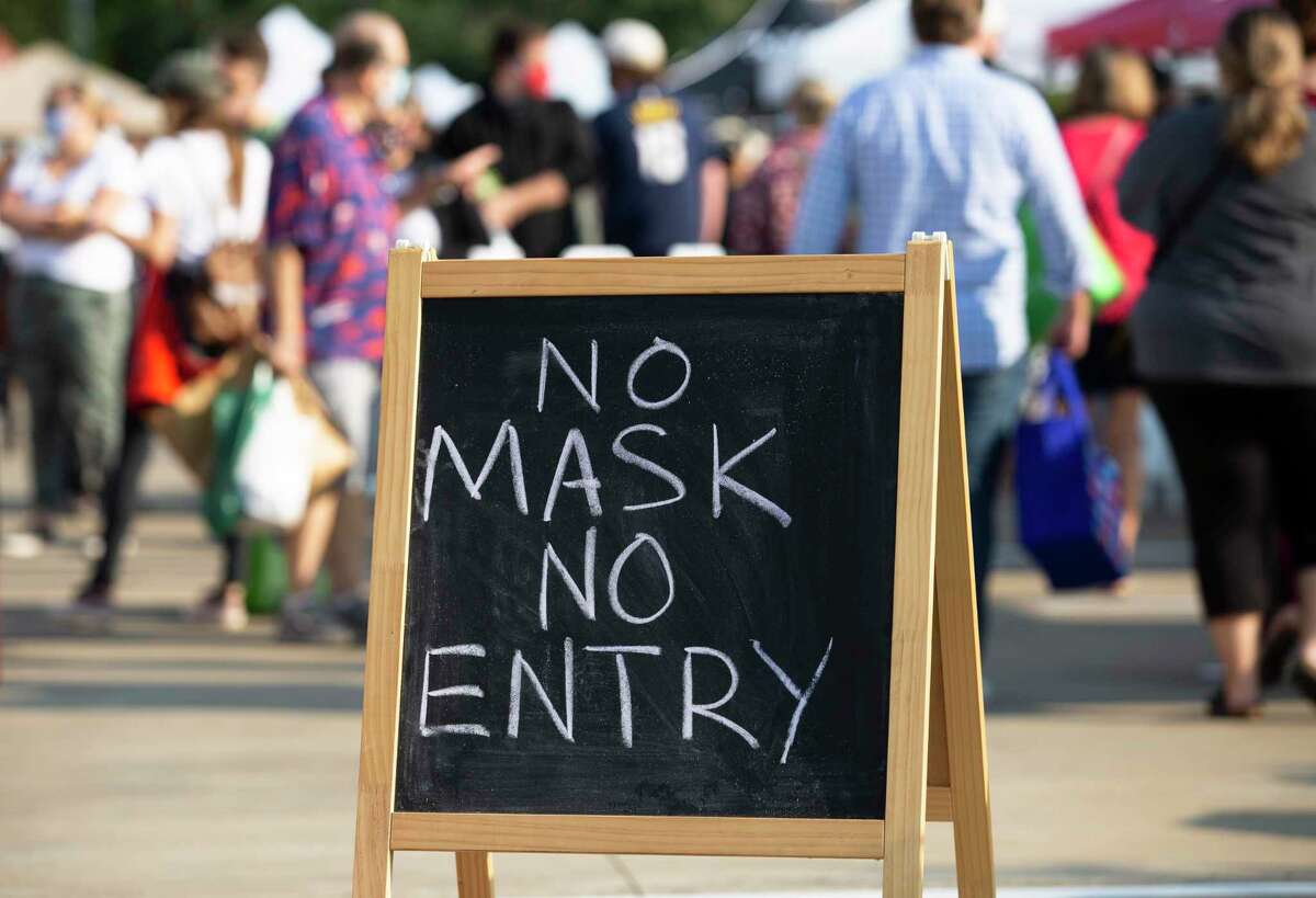People visiting the Urban Harvest Farmers Market, which requires wearing masks for entry, Saturday, Oct. 3, 2020, in Houston.