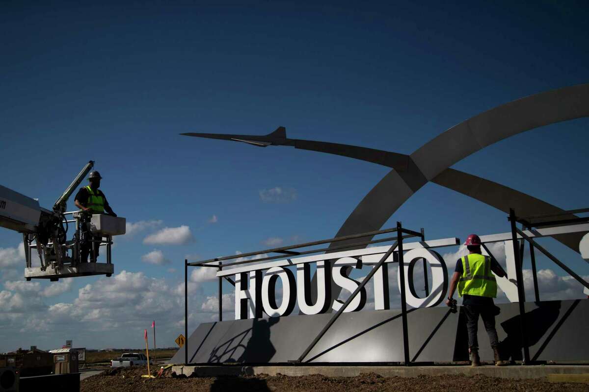 The entrance sign of the Houston Spaceport is being installed by workers, Thursday, Nov. 5, 2020, in Houston.