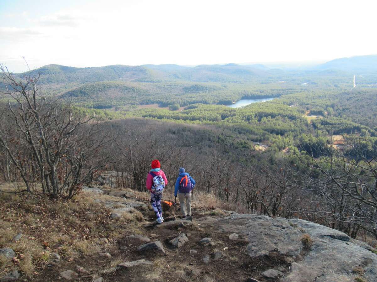 Outdoors writer Gillian Scott and her daughter descend Potash Mountain in the Lake George Wild Forest. (Herb Terns / Times Union)