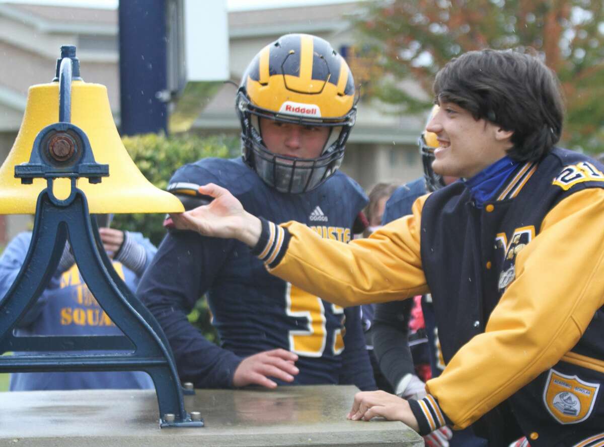Manistee senior Keelan Eskridge rings the Chippewas' victory bell after a win this fall. Eskridge suffered a season-ending injury during his team's season opener, but remained captain from the sidelines.