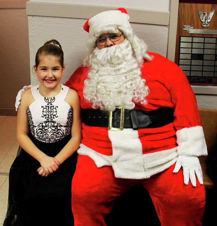 Crowned Snow Princess Rylee Steinman, 8, smiles big with Santa in Elkton last year.