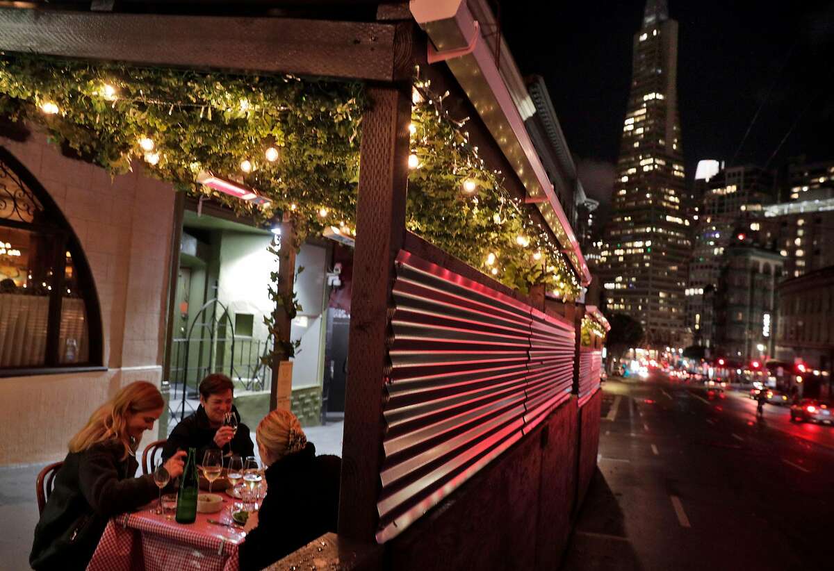 Customers enjoy dinner at the beloved Tosca Cafe in San Francisco, which, after being closed for more than a year and now under new ownership, has reopened for outdoor dining with an elaborate parklet.
