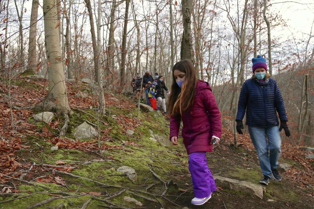 Cara Boland, and Liz Marcal, both of Wilton, work their way along the trail at the Woodcock Nature Center, 54 Deer Run Road, at the sunset hike this past fall, 2020 at the Woodcock Nature Center, located at 54 Deer Run Road this past fall, 2020. Winter program registration for outdoor programs at the center during the colder weather months, this winter, 2021, is now open at the center.