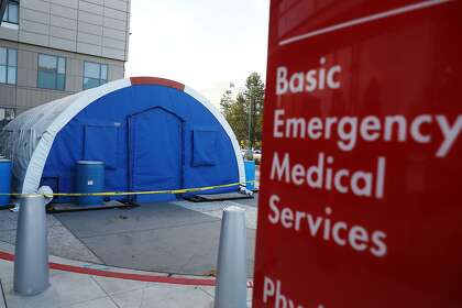 A surge protection tent is in place outside the emergency department at Kaiser Permanente Medical Center in Redwood City.