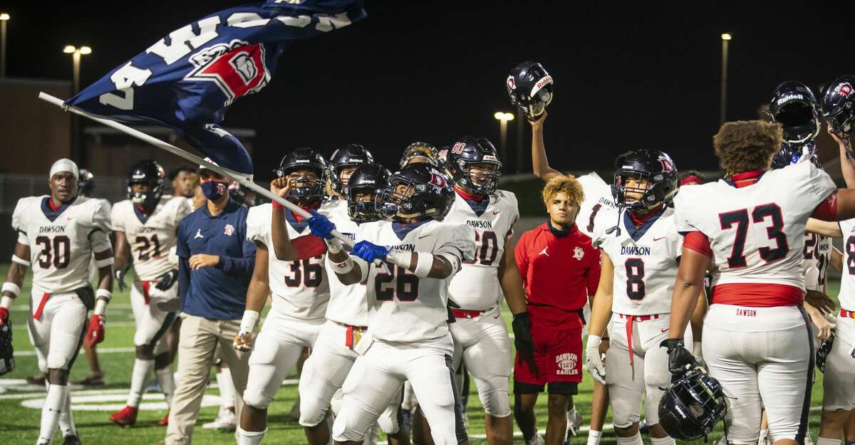 Dawson's Langston Nabors waves a flag as the team celebrates their overtime win during a game between Shadow Creek High School and Dawson High School on Friday, Nov. 20, 2020, at Freedom Field in Arcola, TX.