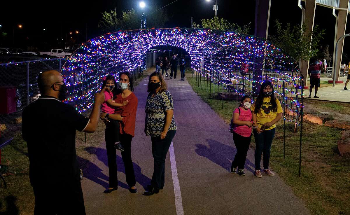Christmas light displays like the one at Jovita Idar’s “El Progreso” Park cut back hours to comply with the city’s curfew.