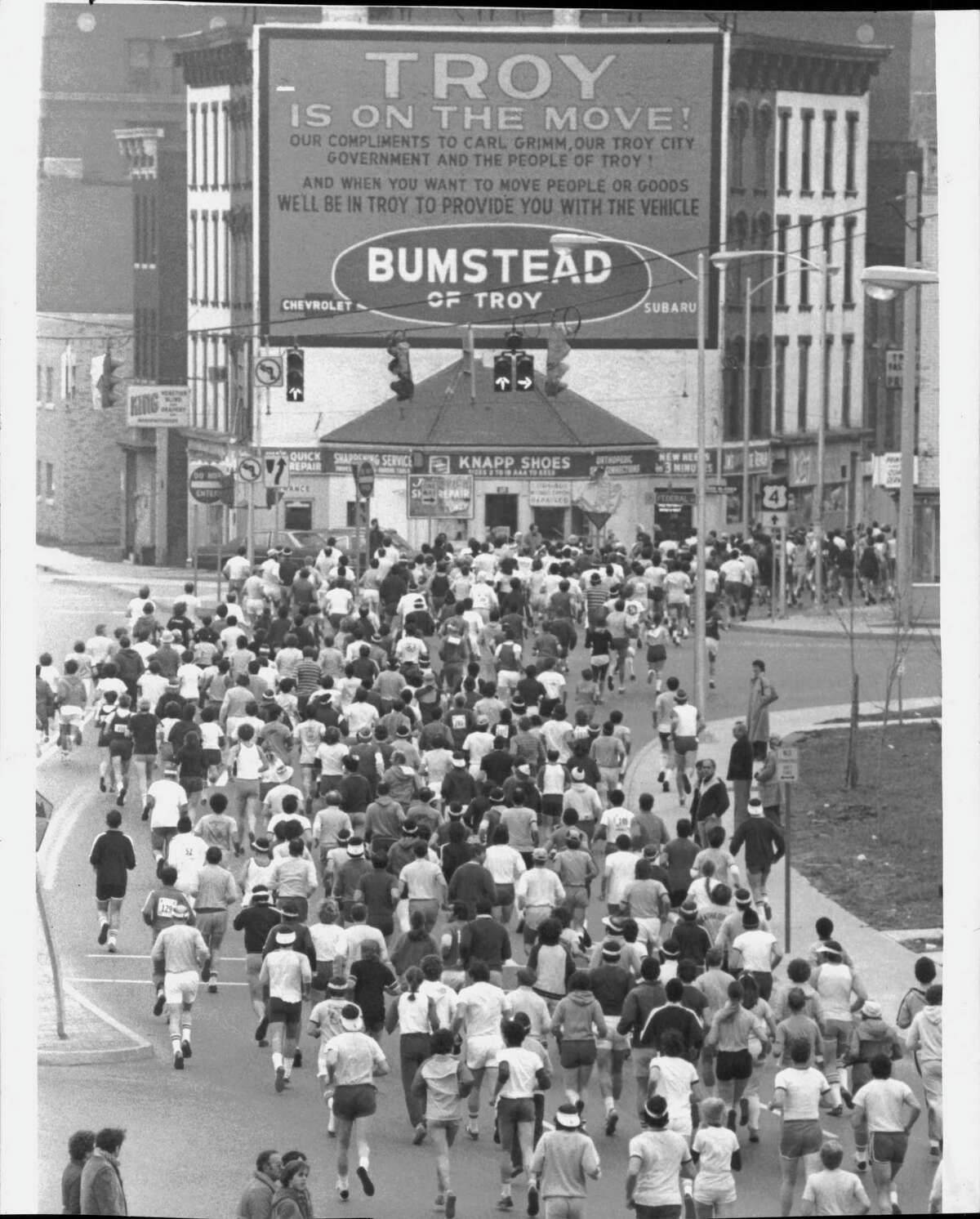 "Troy is on the move" sign sponsored by Bumstead of Troy towers above Turkey Trot runners on  Nov. 22, 1979 (Paul Kniskern/Times Union Archive)